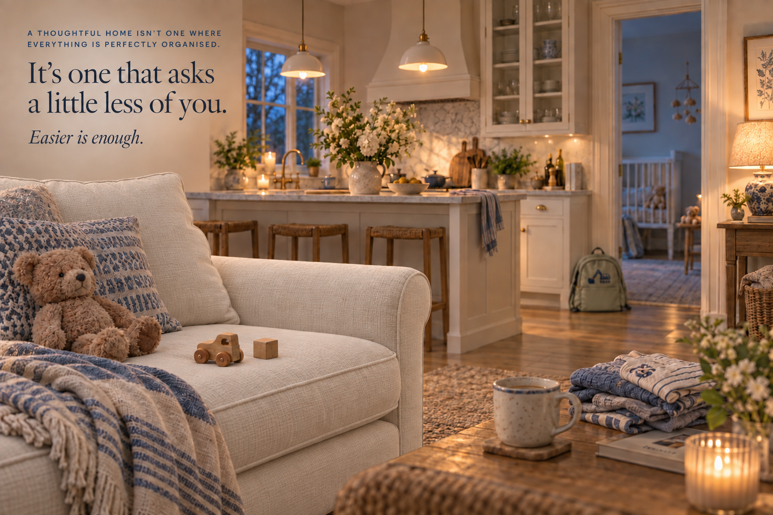 A quiet evening in a lived-in family home, with toys, folded clothes, a nursery bag ready and a lamp lit. A thoughtful home is one that asks a little less of you. Easier is enough.